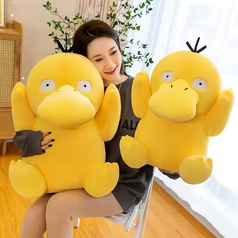 Model holding two Psyduck plush dolls in large and medium sizes for gift and display reference