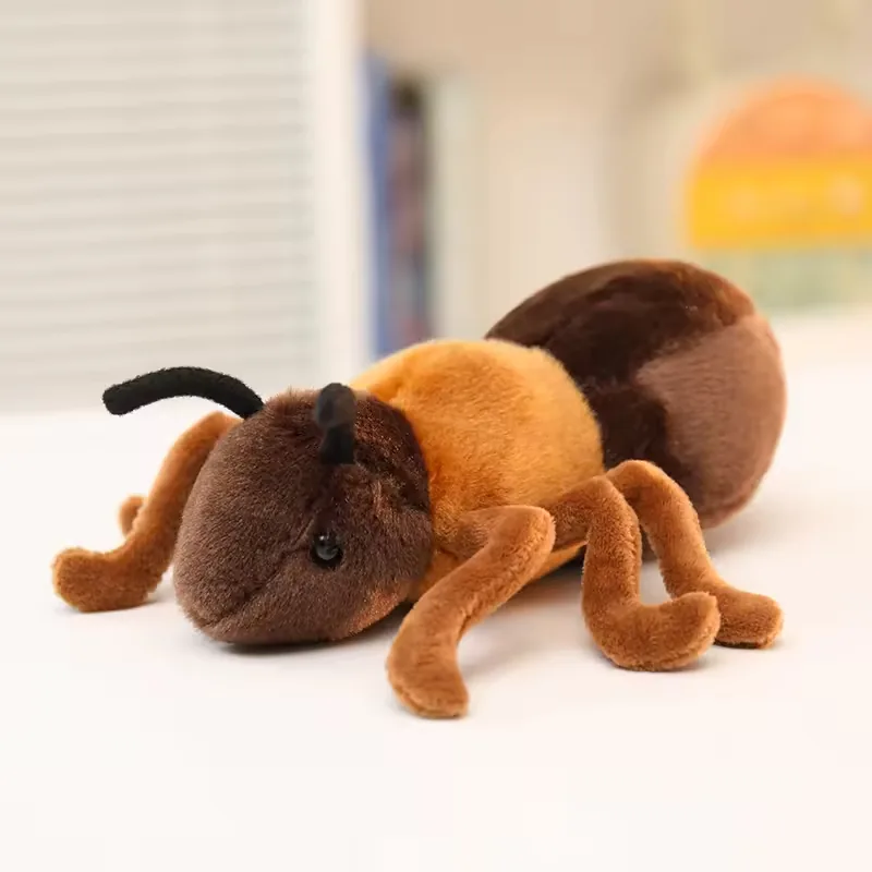 Realistic ant plush toy displayed on a tabletop with soft focus background lighting