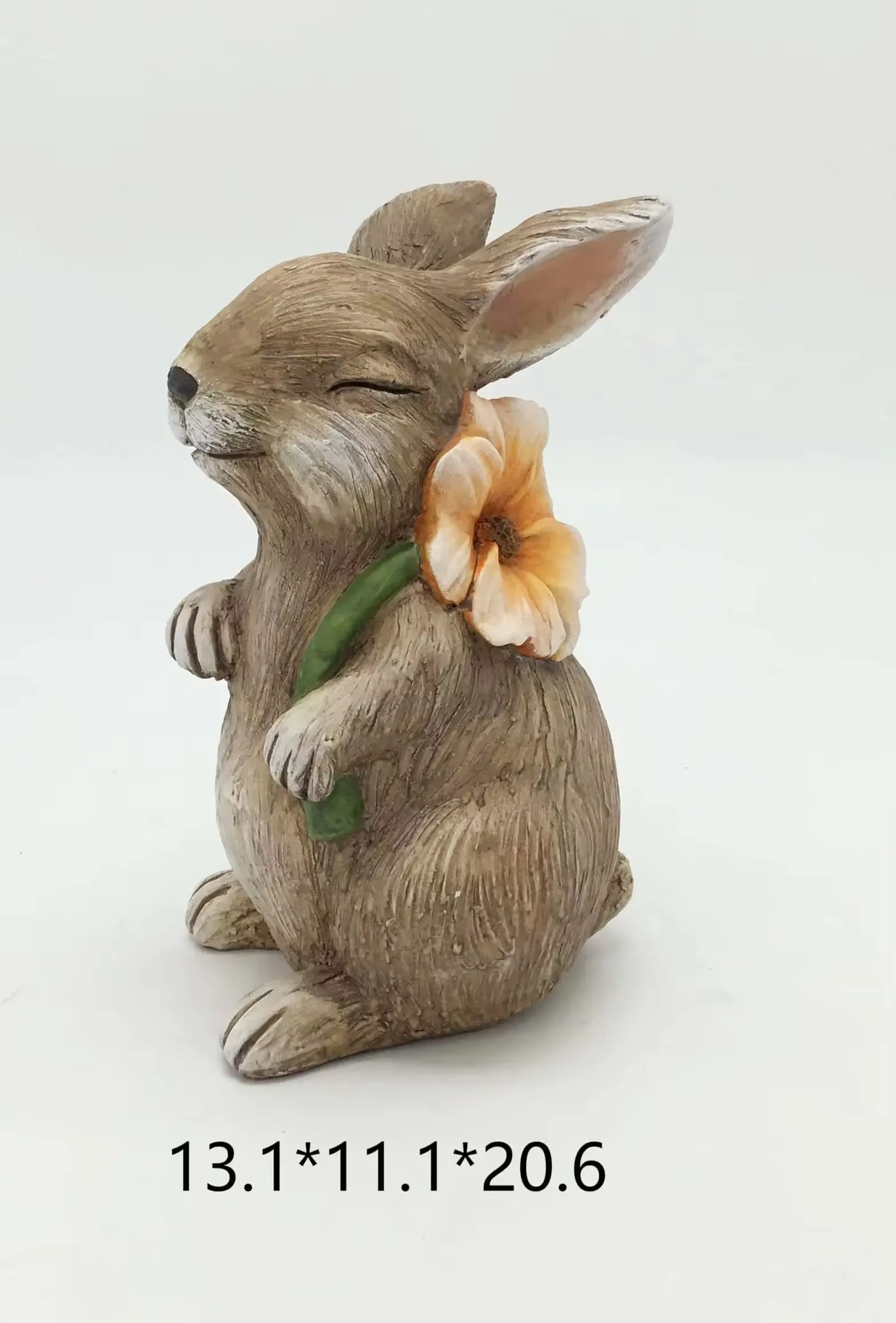Small realistic resin rabbit figurine holding an orange flower for checkout add-on and Easter gift displays