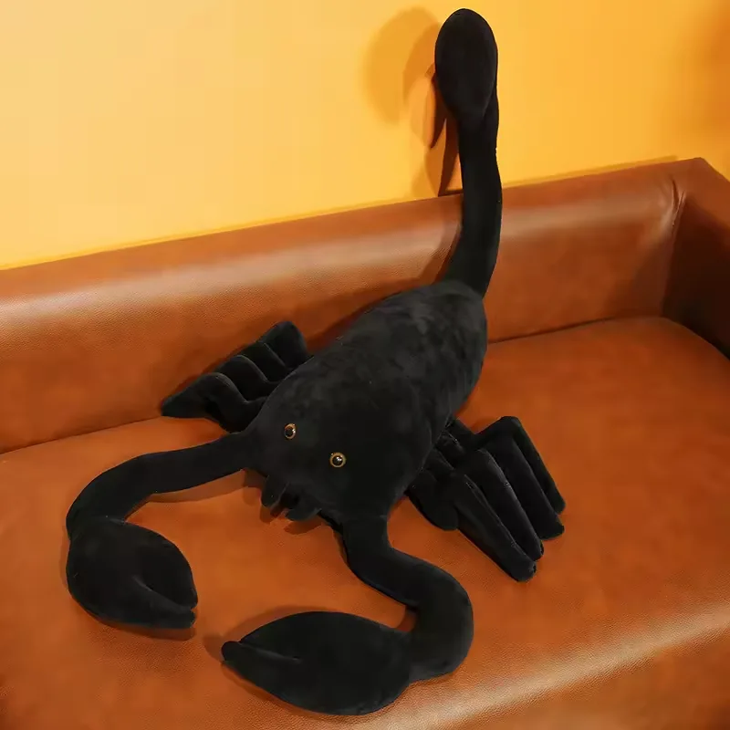 Realistic black scorpion plush doll posed on a sofa with oversized claws and an upright tail
