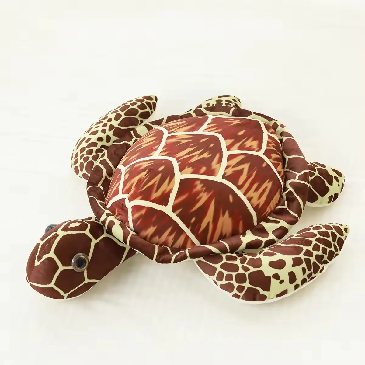 Brown realistic sea turtle plush pillow with printed shell, rounded head, and flat flippers on a white background
