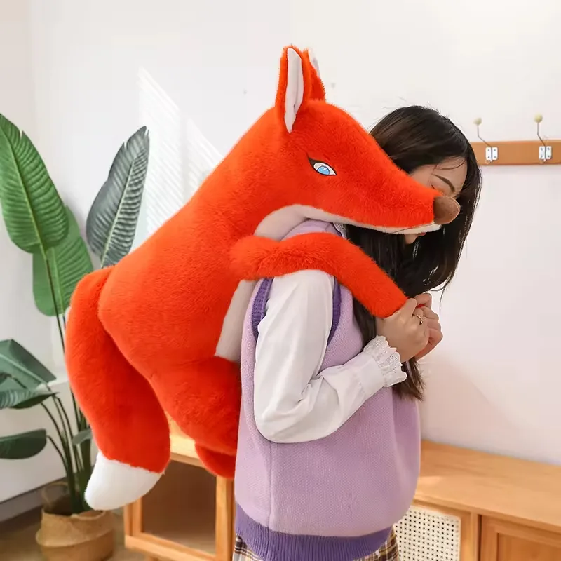 A large red fox plush doll draped over a person's shoulder to demonstrate oversized body length and soft flexibility