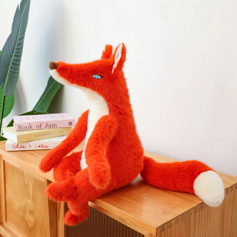 Side profile of a red fox plush doll with a long pointed snout, upright ear, and curled seated legs