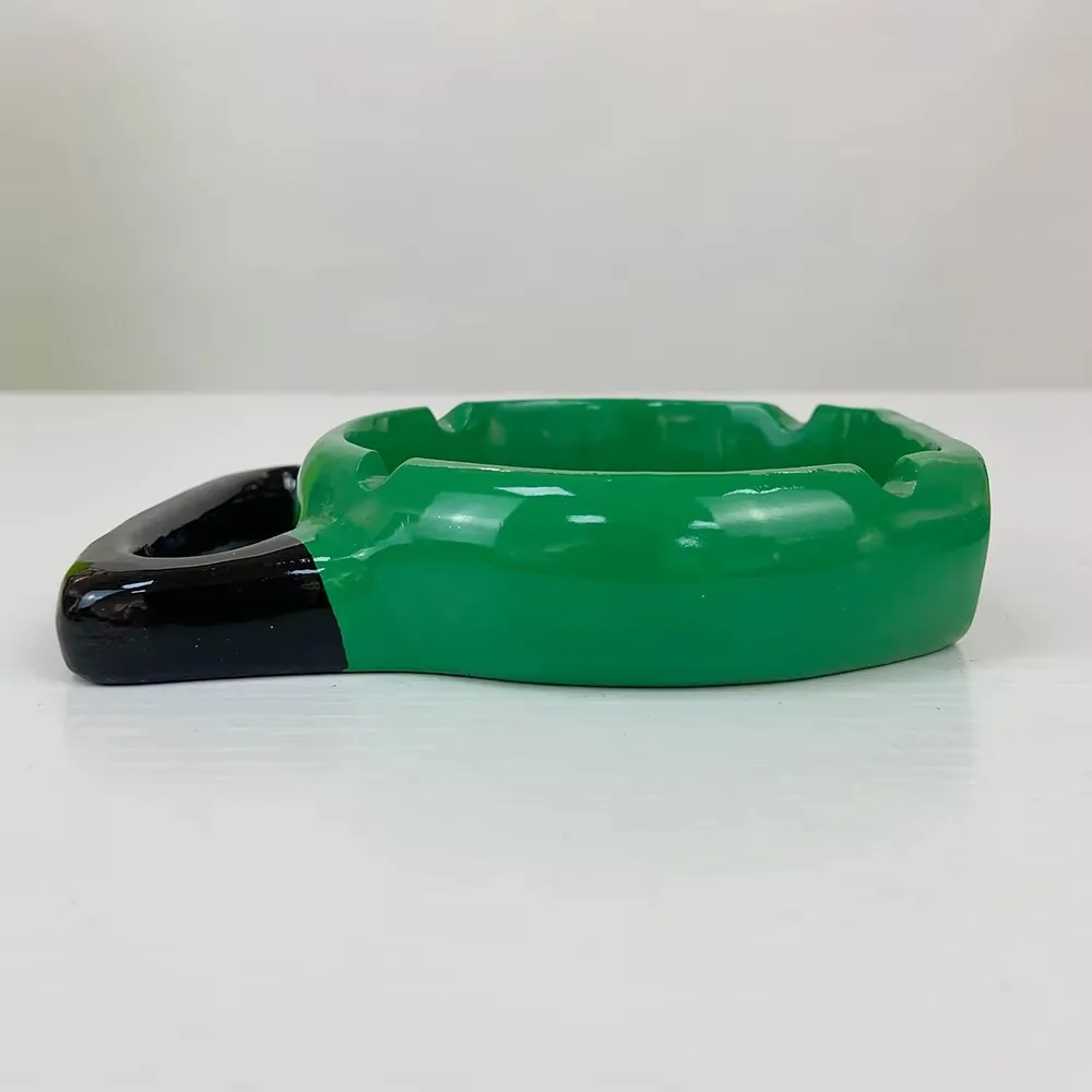 Angled display view of a resin ashtray with sports barbell styling