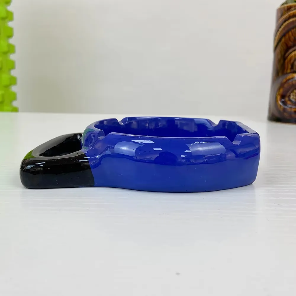 Resin ashtray with sports barbell design shown in a compact desktop display view