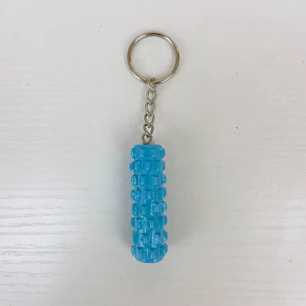 Front view of a blue foam roller resin keychain with raised grid texture and hanging chain