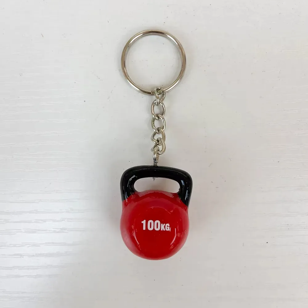 Front view of a red 100KG kettlebell resin keychain with glossy surface and black handle