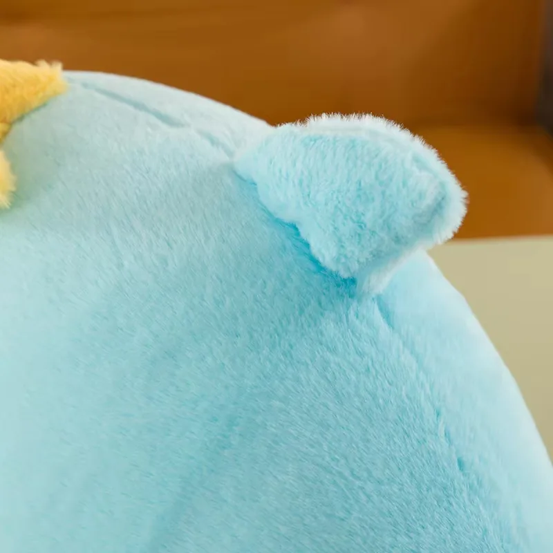 Top-side view of the blue dolphin plush pillow dorsal fin detail