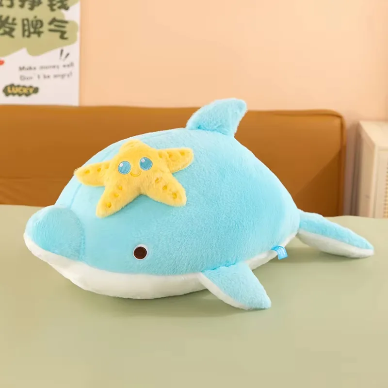 Blue starfish dolphin plush pillow with white belly panel and yellow applique on top