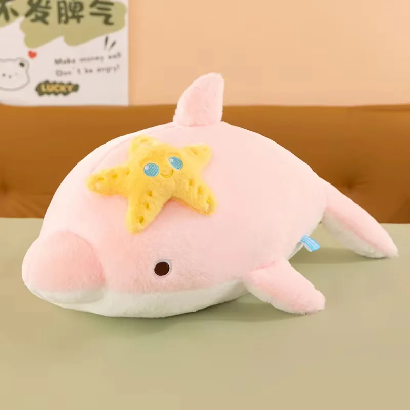 Pink starfish dolphin plush pillow with soft pastel body and smiling yellow starfish applique