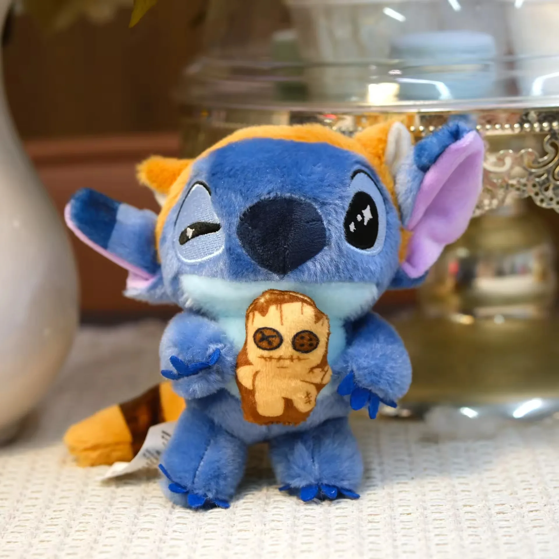 Stitch keychain plush holding a cookie accessory with themed orange details