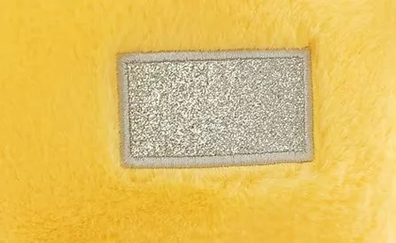 Close-up of the yellow Teletubbies plush doll belly panel detail on the front body