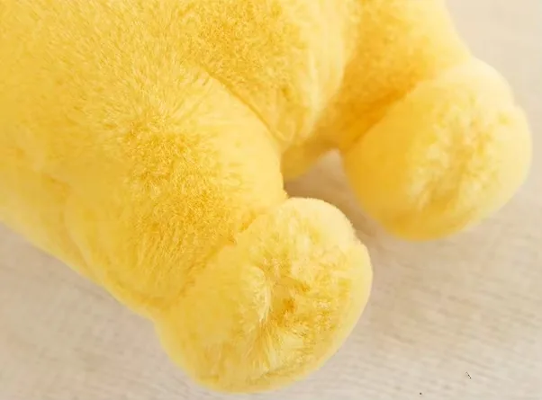 Close-up of the yellow Teletubbies plush doll feet showing soft full PP cotton stuffing