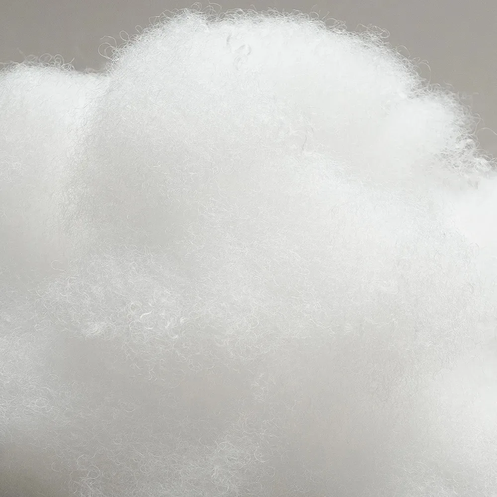 Close-up of high-quality polyester fiberfill showing fluffy white fibers used for plush toy stuffing