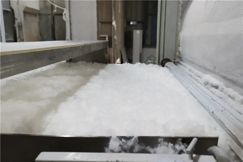Premium polyester fiberfill moving through a processing line before being used in plush toy production