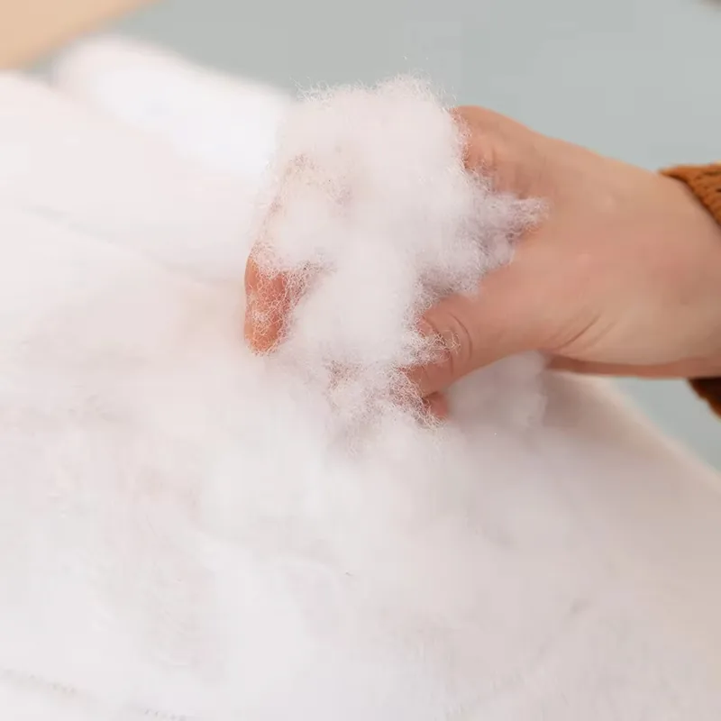 Hand showing the white filling material used inside the whale plush pillow